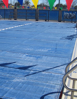 ThermGard thermal swimming pool cover in use at an outdoor pool.